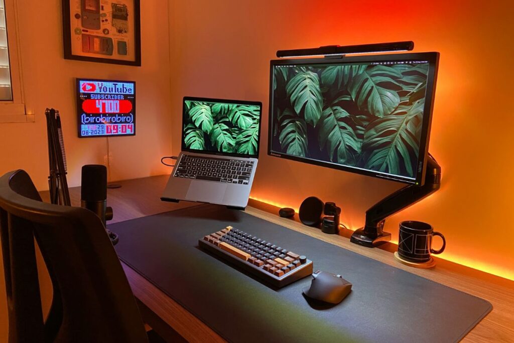 monitor arm on minimal oak desk setup