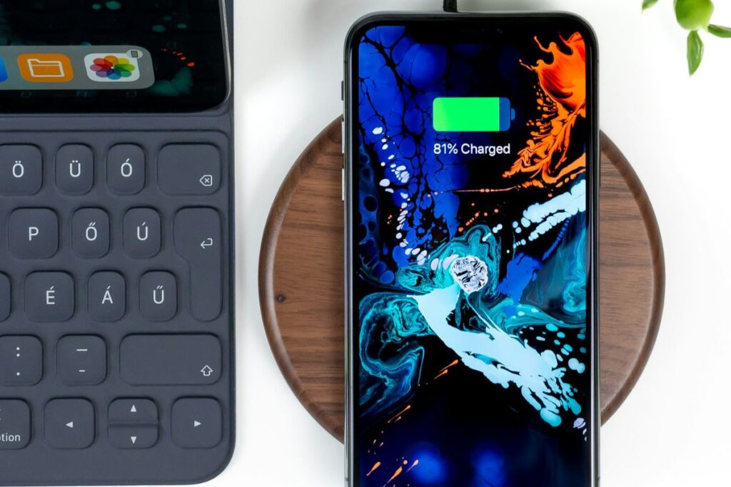smartphone charging wirelessly on flat minimal pad