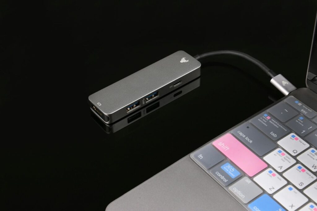 compact usb c hub connected to laptop on desk