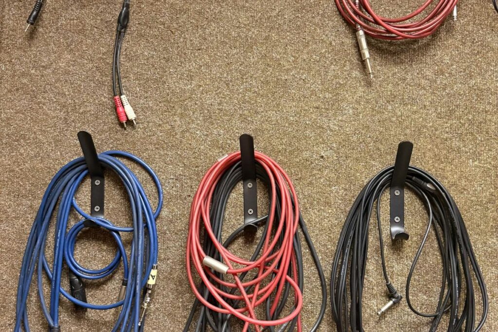 magnetic cable clips holding charging cables on desk edge